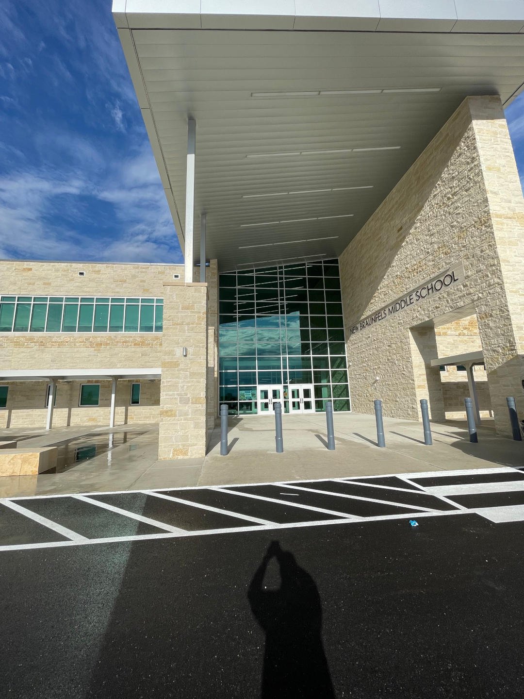 New Braunfels ISD – New Braunfels Middle School  New Braunfels Middle School is a 190,682 SF, two-story building on a 67 acre site.  Construction elements include a structural void form slab, steel frame, modified bitumen and standing seam roofing, porcelain tile, and LVT flooring.  The exterior is clad with face brick, natural stone, and metal panels.  The facility includes classrooms, wood floor gymnasiums, science labs, food service, administration, and fine arts areas.  On site improvements include concrete paving, covered walkways, site utilities, athletic fields, running track, and tennis courts.  Back to Portfolio 