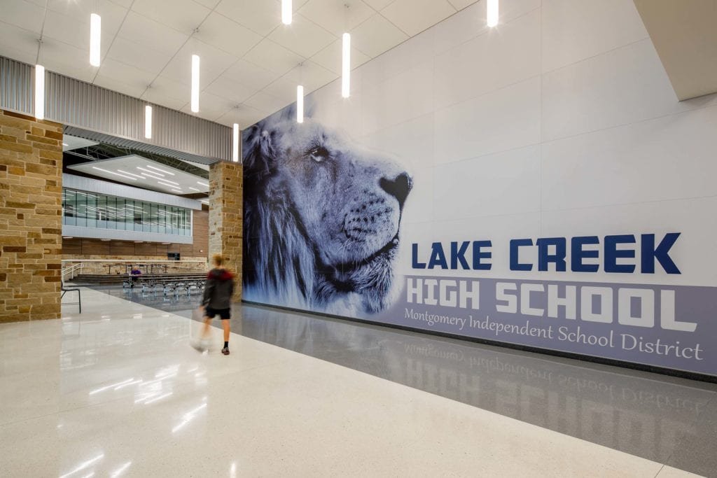 Montgomery ISD – Lake Creek High SchoolThe 130 acre site subdivided by a seasonal creek included such significant elevation variation that there was 20’ of cut/fill required to prepare a suitable building pad.  Additionally, expansive soils required a structural slab.  The impressive 382,000 SF structure is framed with conventional structural steel and utilizes a mixture of face brick, stone and metal panel veneer for exterior surface and features a standing seam roof on much of the building.  The building includes an auditorium with acoustical shell, multiple gymnasiums and food service facilities.  Interior finishes include terrazzo floors, LVT and ceramic tile.  Scope also includes competition baseball, softball and football fields, running track, tennis courts and greenhouses.Back to Portfolio